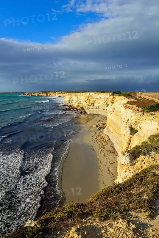 Cliffs in the evening light with rain clouds