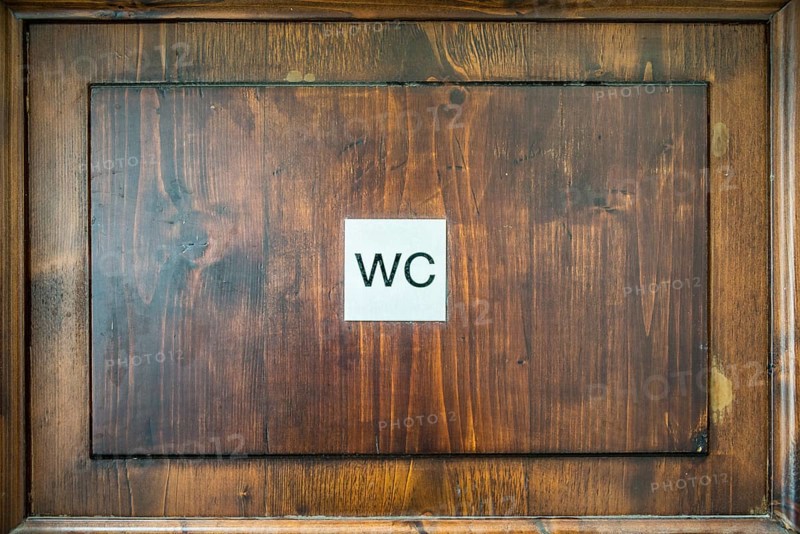 Toilet sign on a wooden door