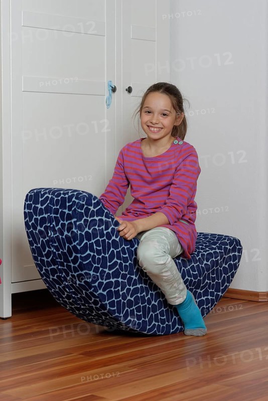 Girl on a child's rocking chair