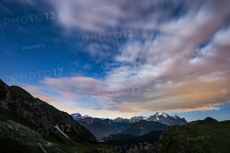 Marmolada glacier in a starry night with clouds
