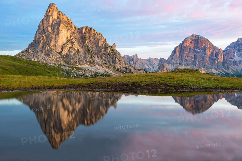 Gusela mountain at sunrise reflected in small lake