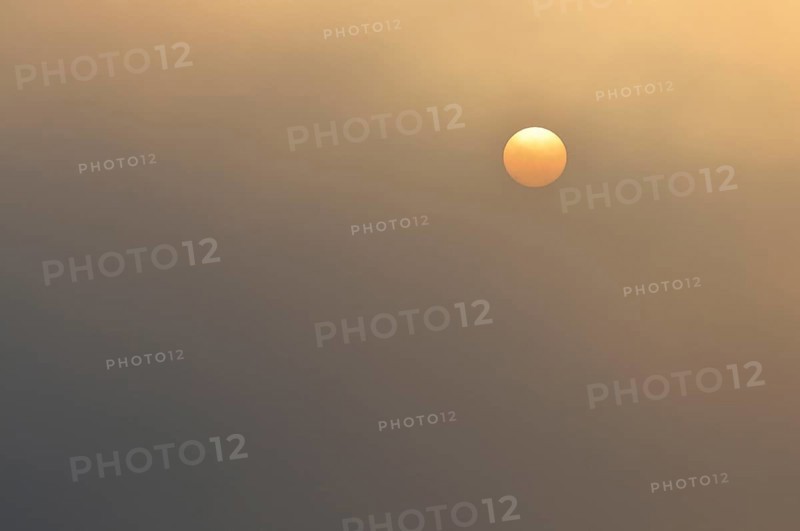 Sun at sunrise with fog