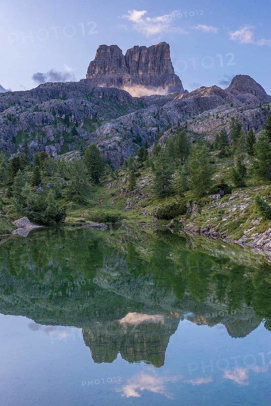 Mount Averau at sunrise reflected in lake Limedes