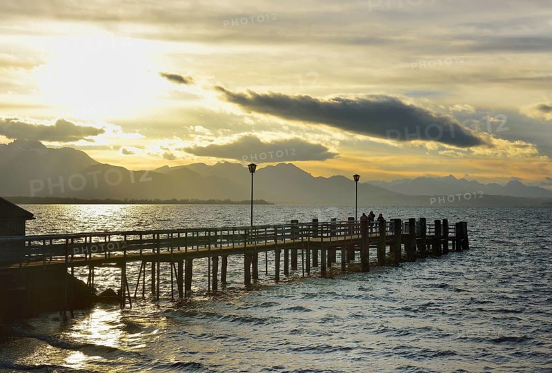Boathouse with jetty at sunset on Lake Chiemsee