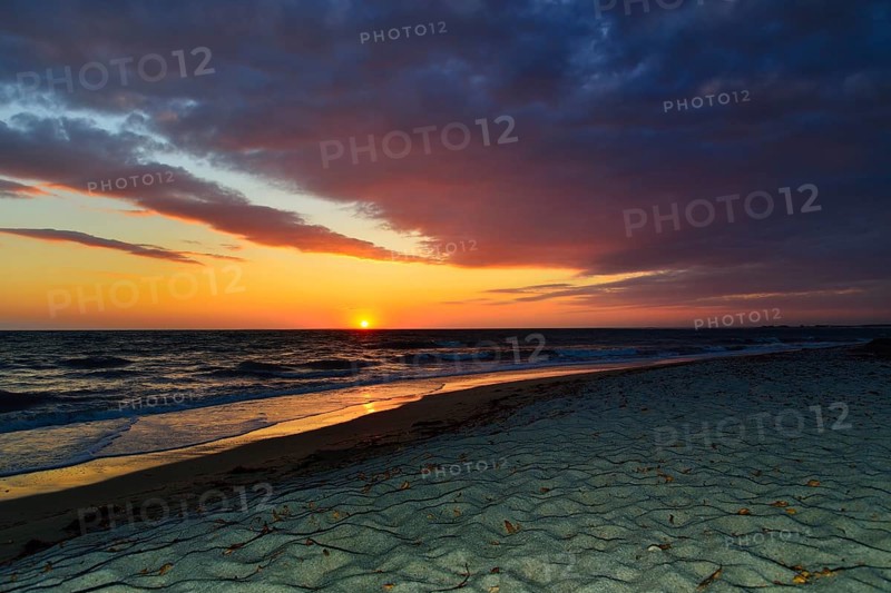Sunset at sea with cloudy sky