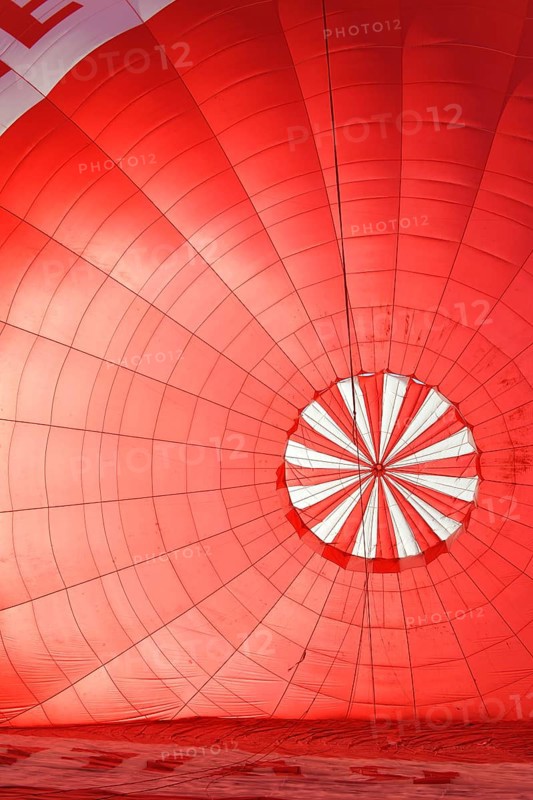 A red hot air balloon being inflated