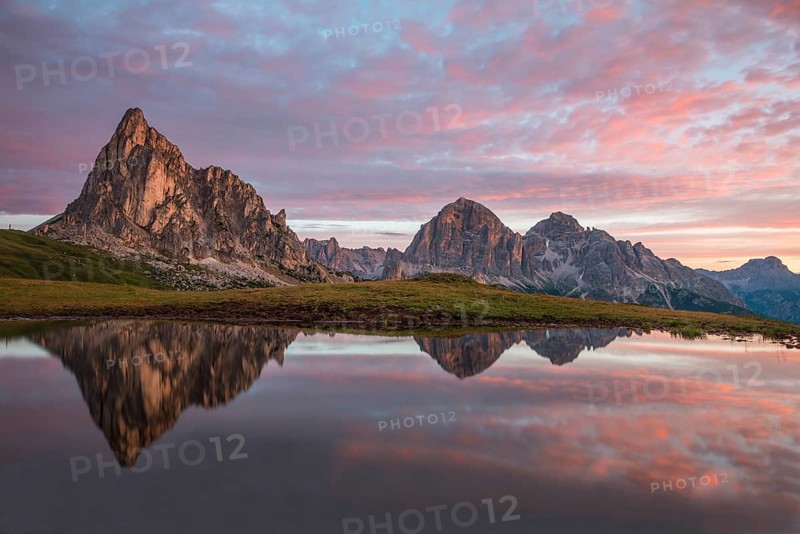 Gusela mountain at sunrise reflected in small lake