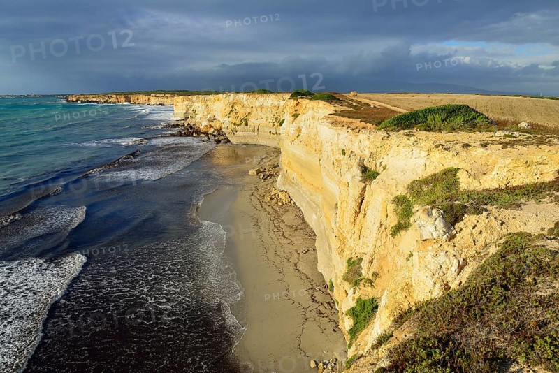 Cliffs in the evening light with rain clouds