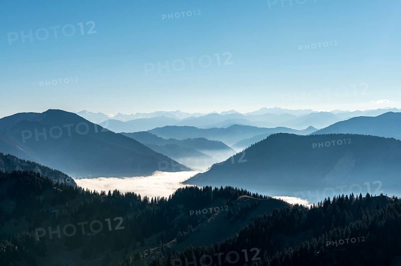 Mountain chains one behind the other in back light