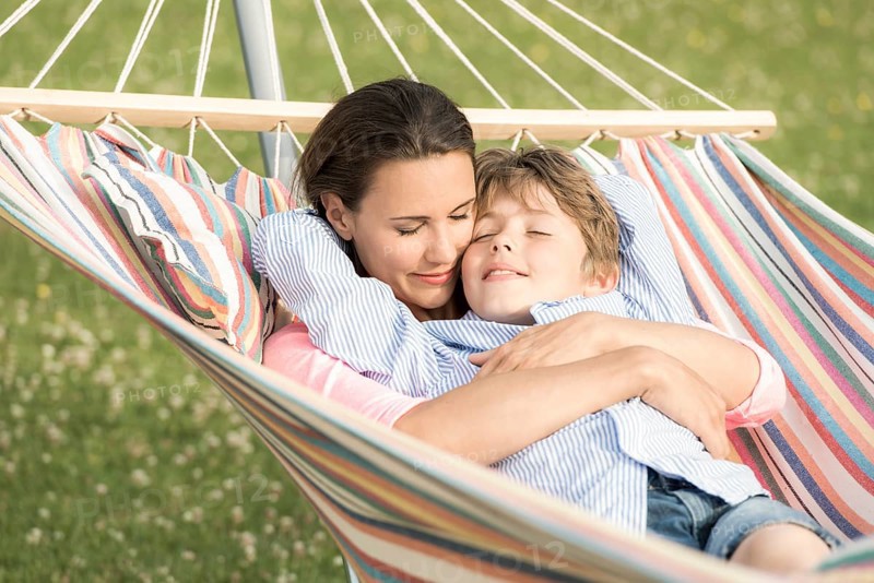 Mother and son lying in hammocks