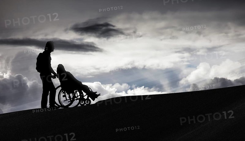 Person pushing a wheelchair