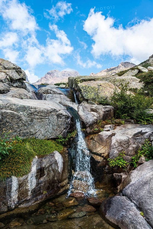 Pool with a small waterfall in the mountains