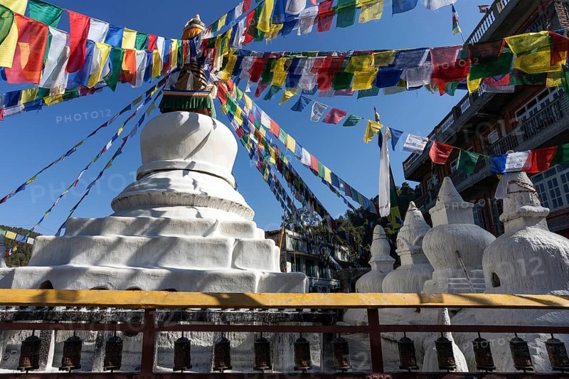 Stupa with prayer flags and prayer wheels