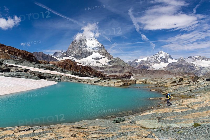 Hiker at glacier lake on the way to the Gandegg hut