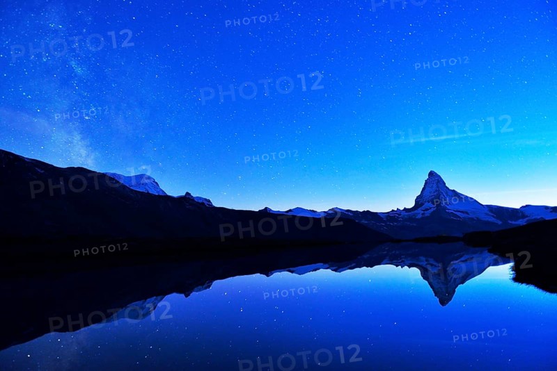 Matterhorn with Milky Way reflected in lake Stellisee