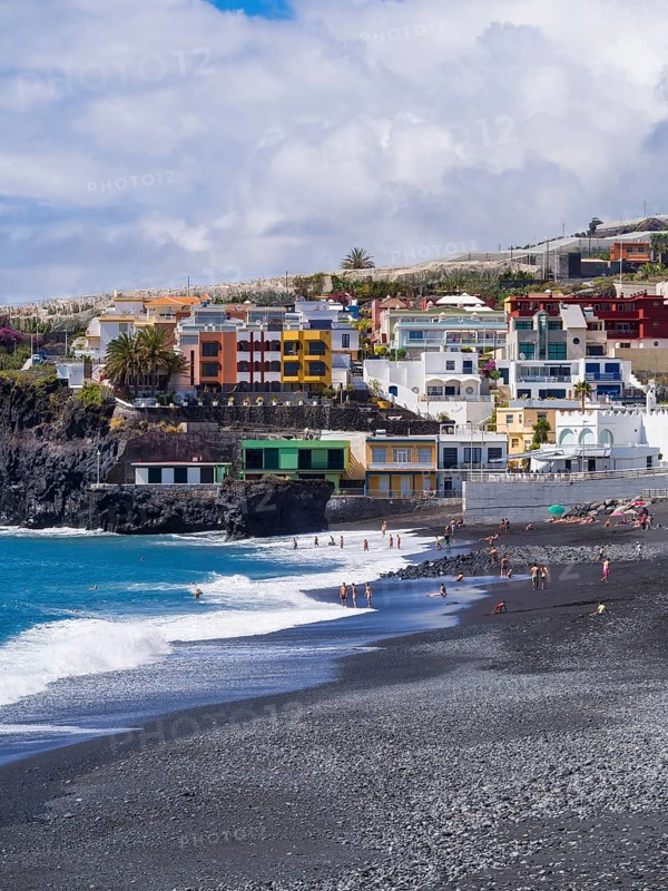 Tourists on the black beach of Puerto Naos