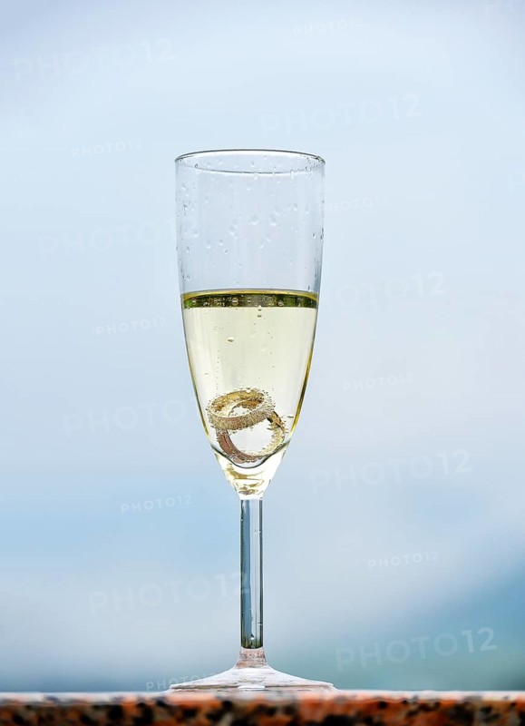 Wedding rings in a champagne glass
