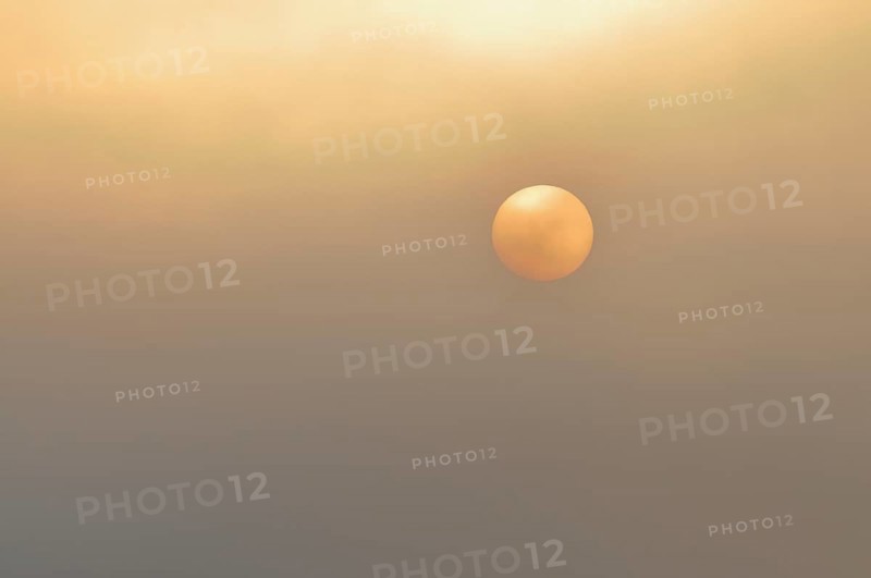Sun at sunrise with fog