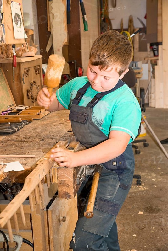 Farmer's son repairing a hay rake