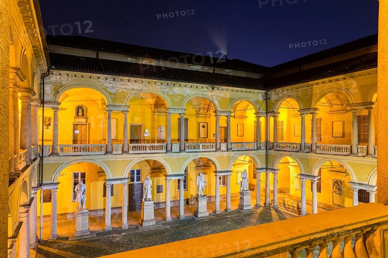 Illuminated courtyard with loggia and sculptures