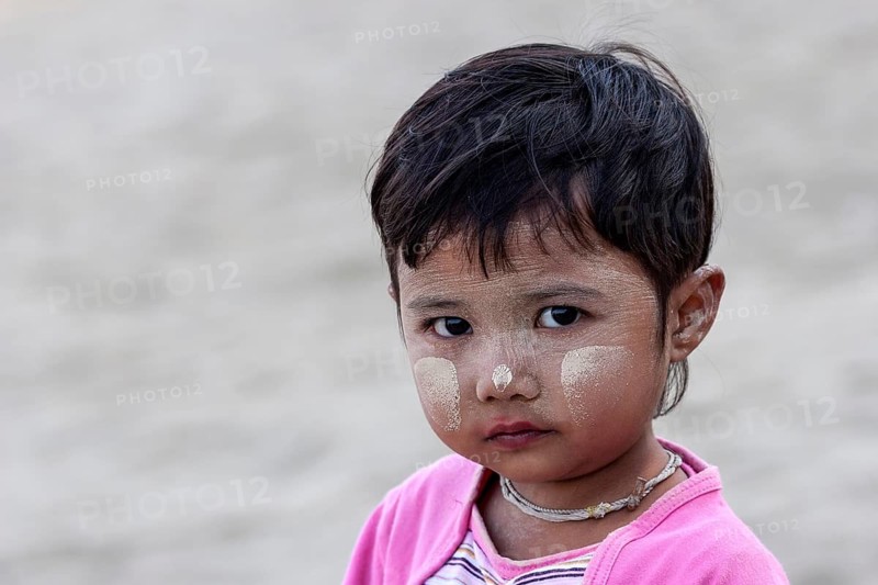 Girl with Thanaka paste on her face