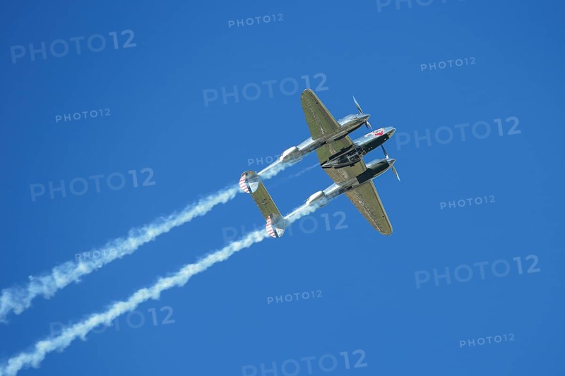 A Lockheed P-38 Lightning flying in a flight display during the Red Bull Air Race