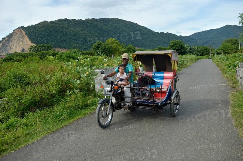 Man with child on motorcycle Rick Shah