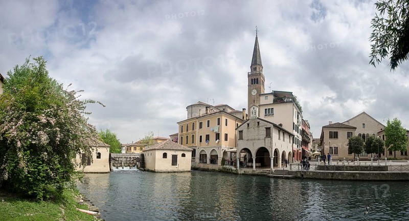 The leaning tower of the cathedral and the old mill