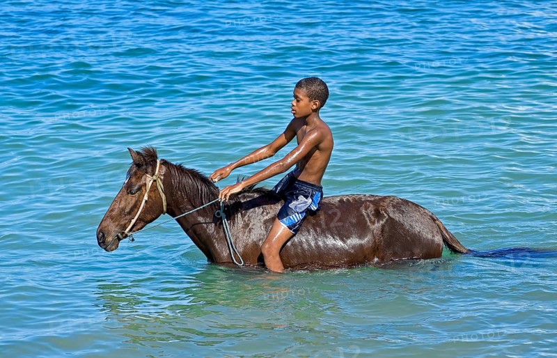 Boy on horseback in the sea