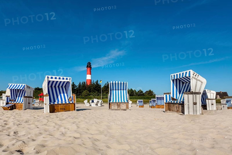 Beach chairs on the beach in front of the lighthouse