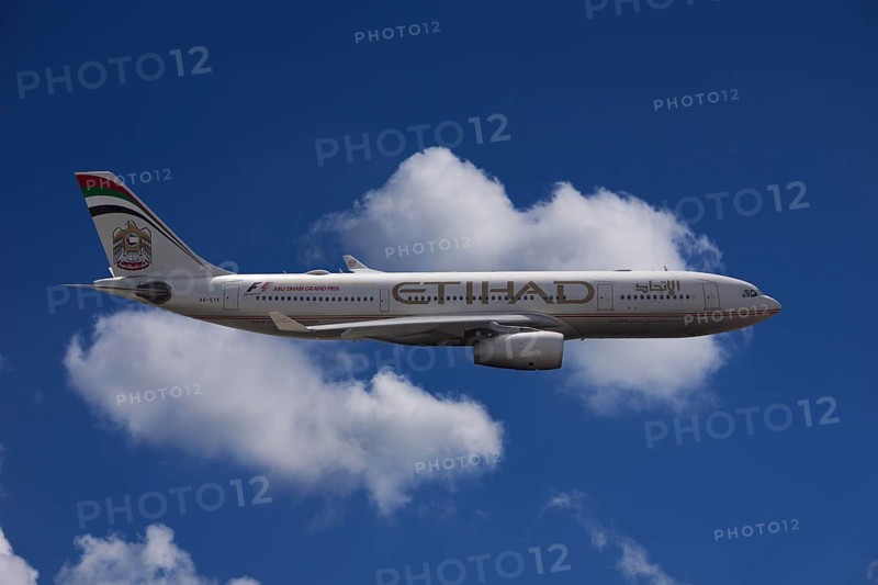 A6-EYK Etihad Airways Airbus A330-243 in flight against a cloudy sky