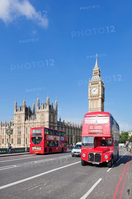 Red double decker buses on Westminster Bridge with Big Ben and Houses of Parliament