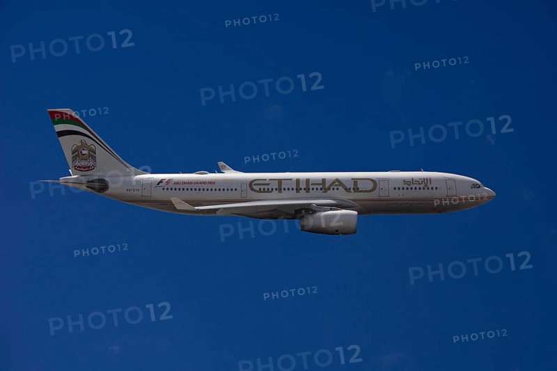 A6-EYK Etihad Airways Airbus A330-243 in flight against a blue sky