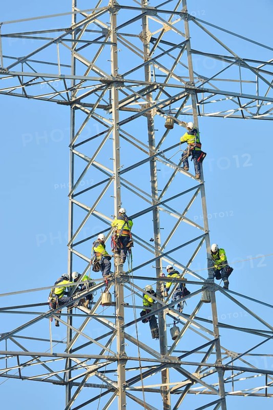Overhead linemen working on a pylon