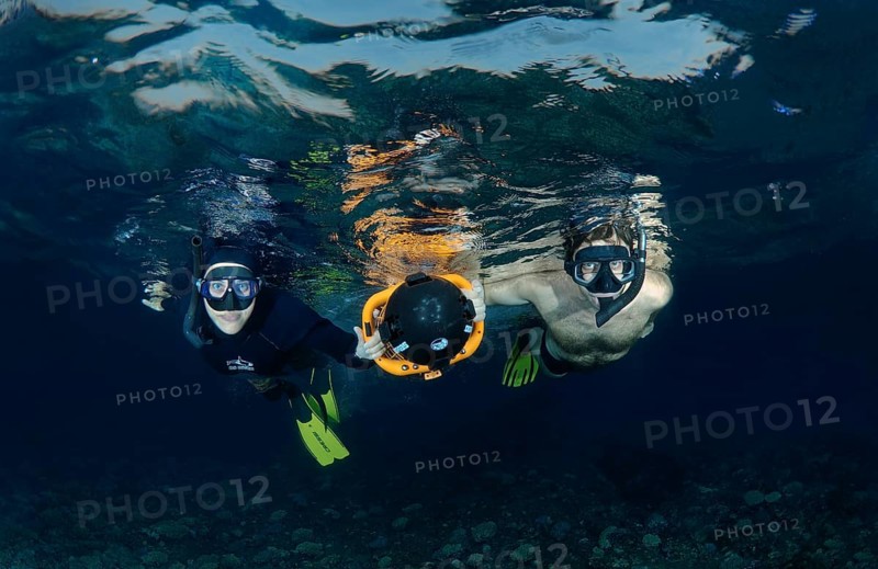 Freediver with an underwater scooter
