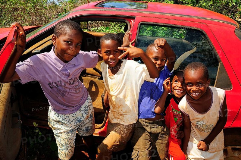 Happy children playing at a car wreck