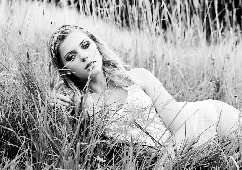 Young woman in lingerie posing outdoors