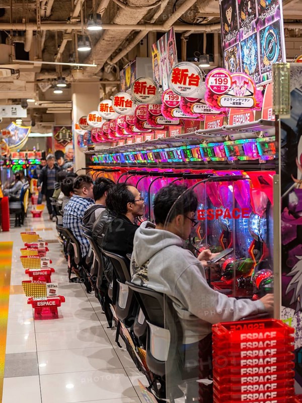 Players sit at slot machines in a casino