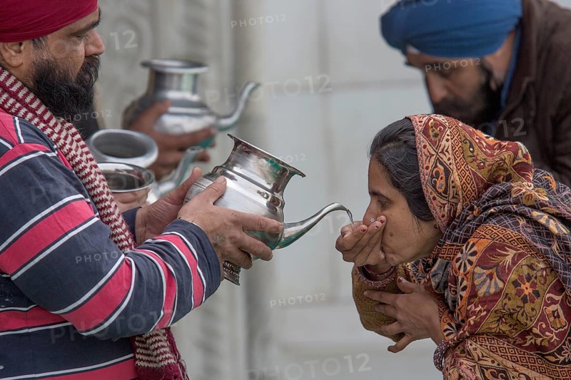 Pilgrims drinking holy water