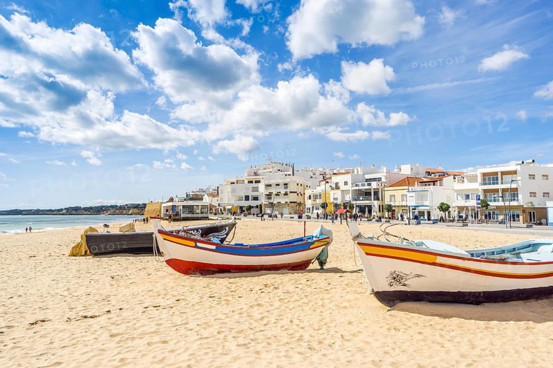 Colorful boats on the sandy beach in fishermen village of Armacao de Pera