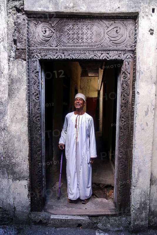 Proud Comorian man standing in doorway