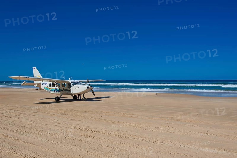 Small plane landing on the 75 Mile Beach