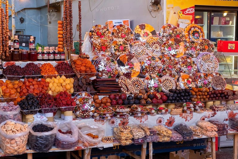 Stall in market hall with candied fruits