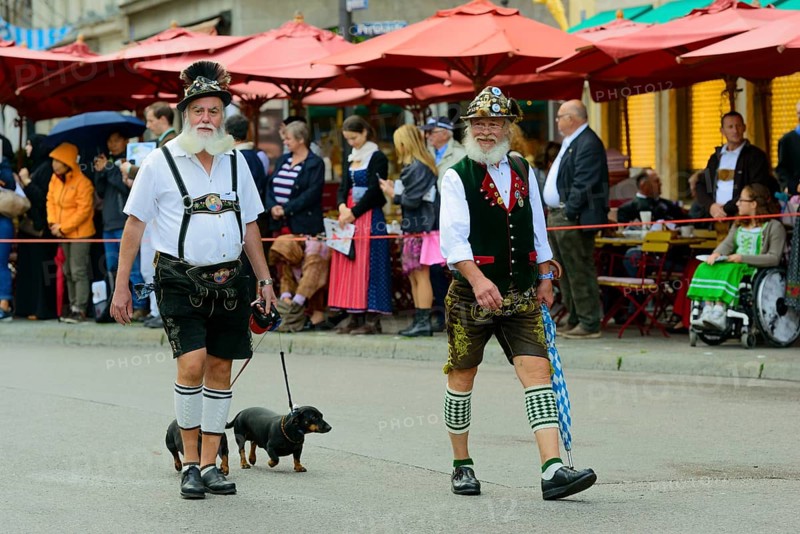Two Munich men in traditional costume with a Dachshund