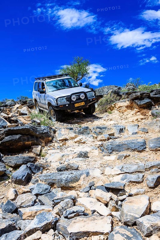 SUV driving down rock steps