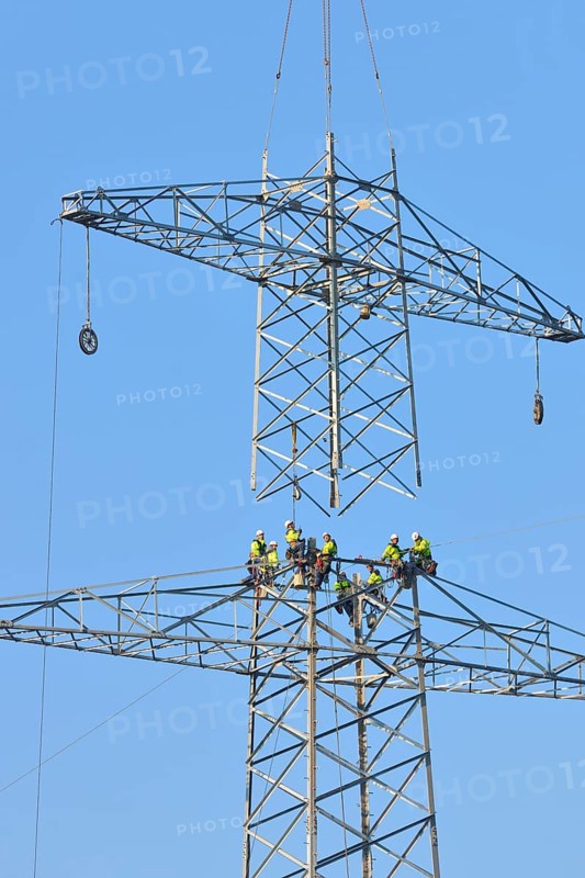 Overhead linemen working on a pylon