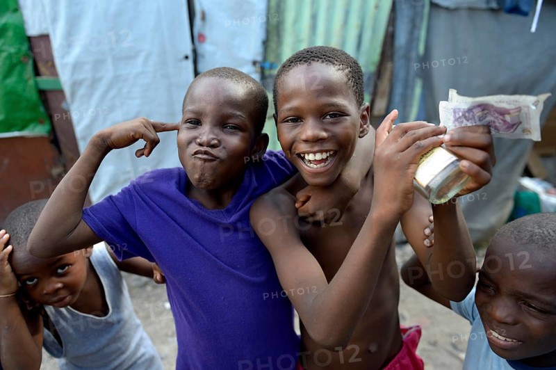 Two boys posing with money