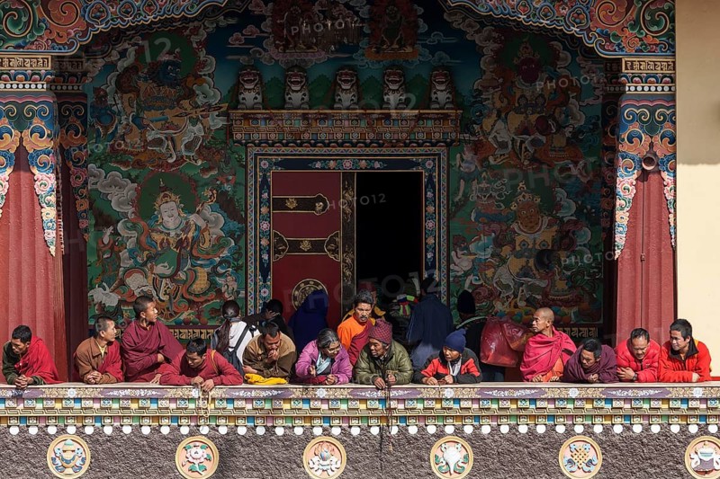 Native people on the balcony of the Cinya Llama Gompa