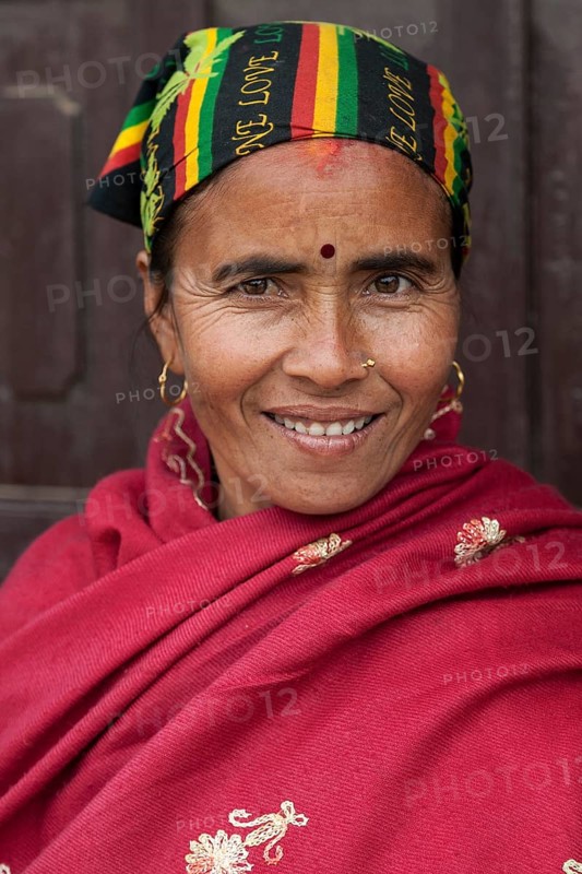 Nepalese woman with colourful headscarf and red cape