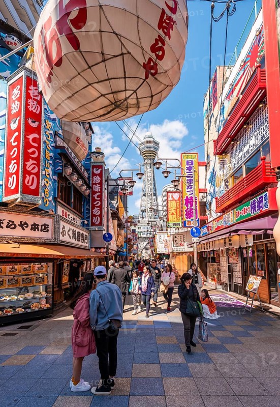Many colorful advertising signs in a pedestrian zone with shops and restaurants